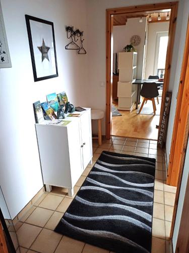 a hallway with a white cabinet and a black rug at Ferienwohnung in Sponsheim in Bingen am Rhein