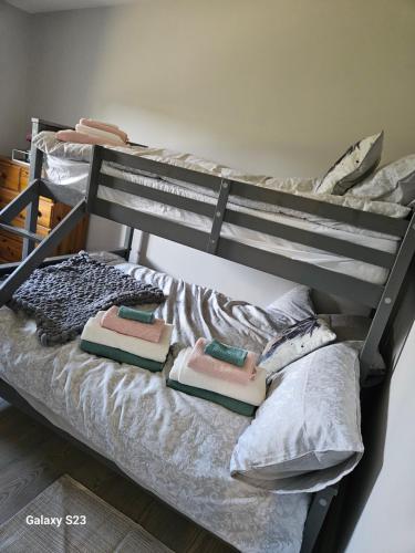 a bunk bed with pillows on it in a room at GL farm and stables guest house in Kilberry