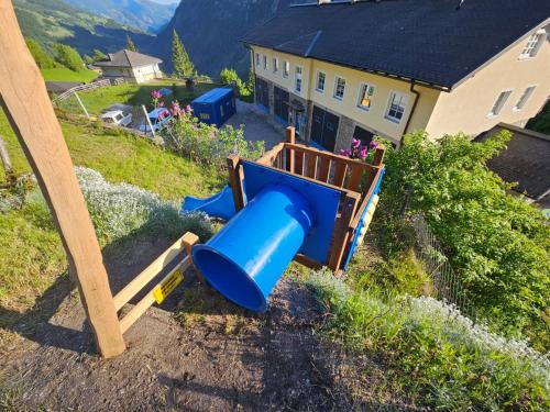 a blue slide in a yard next to a house at Haus Traumhorst in Heiligenblut