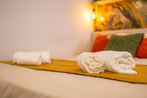 two towels on a bed in a hotel room at Smart Studio, AC ,Fast Wi-Fi & Walk to Marina by QuickTrips in Taʼ Xbiex