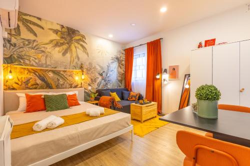 a bedroom with a large bed and a living room at Smart Studio, AC ,Fast Wi-Fi & Walk to Marina by QuickTrips in Taʼ Xbiex