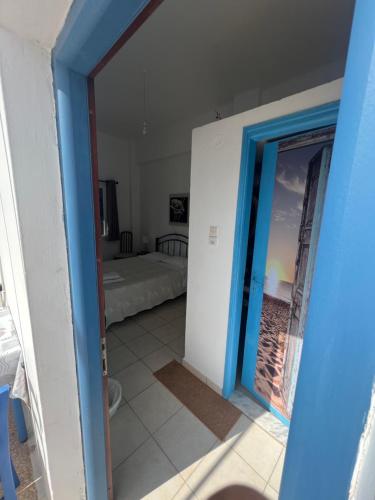 a door leading into a room with a bedroom at Hotel Glaros Lipsi in Lipsoi
