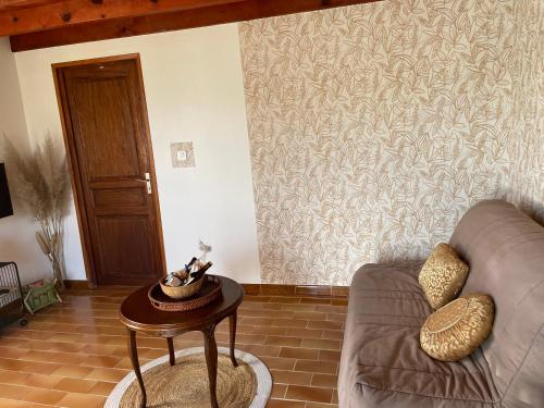 un salon avec un canapé et une table dans l'établissement Studio entre mer et montagne, à Calcatoggio