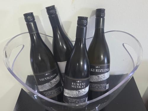 four bottles of wine in a glass basket at Gold Wine Estate in Podlehnik