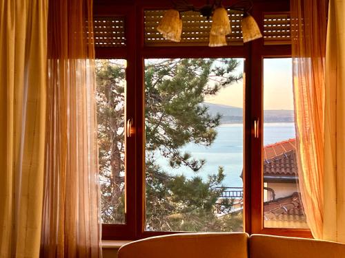 a large window with a view of the ocean at Amara Holiday Santa Marina, Sozopol in Sozopol