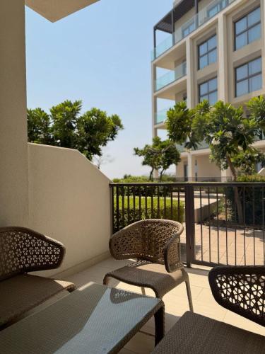 a balcony with a table and chairs and a building at Address Beach Resort Fujairah Apartment Three Bedrooms by Blue World- 2 in Fujairah