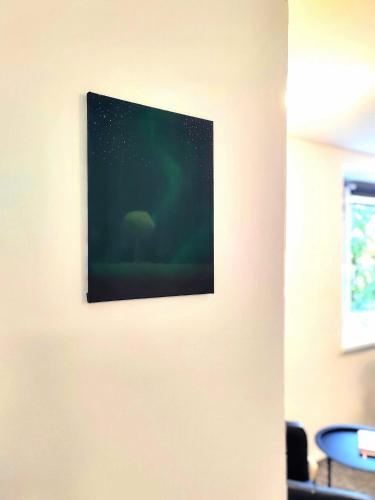 an image of a painting on a wall with a picture at Apartments Merci in Ostrava