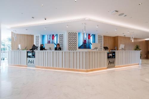 a lobby with a reception desk in a building at Hotel Tahití Playa in Santa Susanna