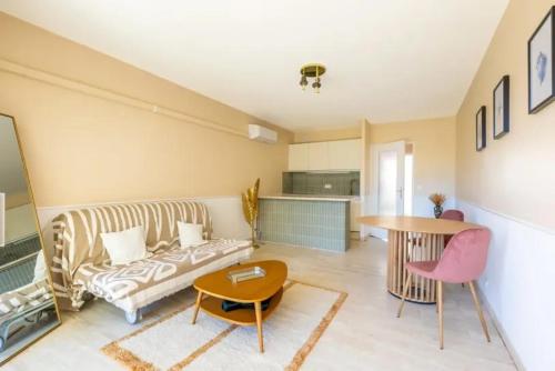 un salon avec un canapé et une table dans l'établissement Studio rénové à Bandol avec jardin privé - 5 min de la plage, à Bandol