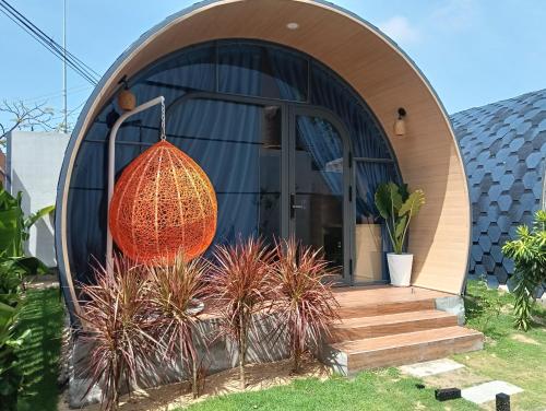 a circular house with an orange orb hanging from it at Sea Breezes-Gió Biển Bungalows in Ấp Long Sơn