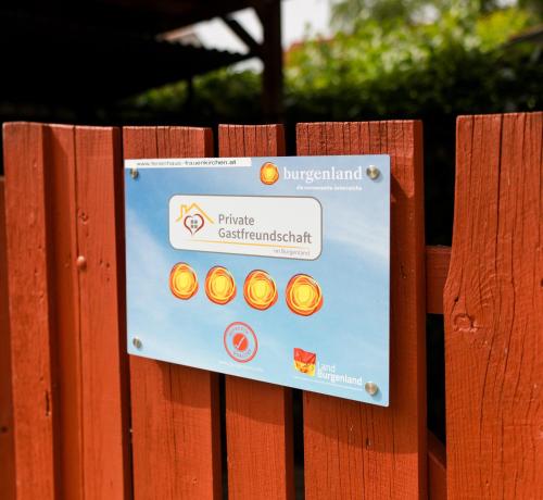 a sign on the side of a wooden fence at Paradies Für Zwei in Frauenkirchen