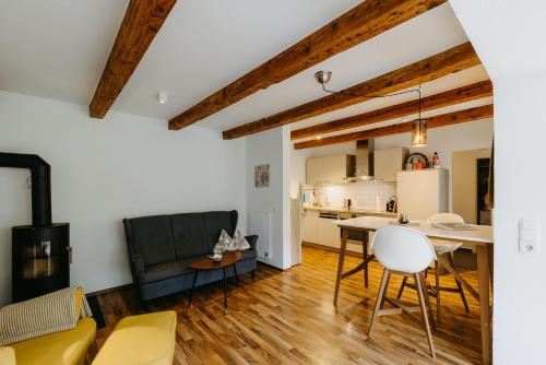 a kitchen and living room with a table and chairs at Paradies Für Zwei in Frauenkirchen