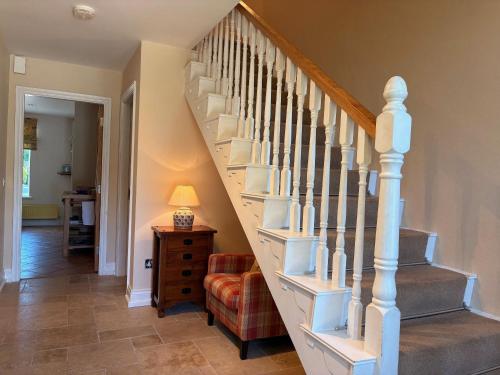 a staircase with white railings in a home at 3 bedroom townhouse in the heart of Kenmare in Kenmare