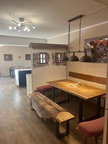 a dining room with a table and a bench at Hacker-Alm in Otterfing
