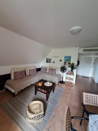 a living room with a couch and a table at Appartement 2 à 6 personnes dans un magnifique complexe de Vacances à Sainte-Luce in Sainte-Luce