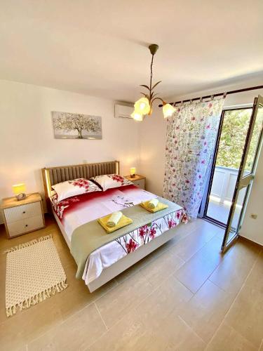 a bedroom with a large bed and a window at Apartman Miljenko - Matovica in Kampor