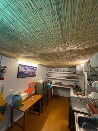 a kitchen with a ceiling with a green roof at Tapas Stays in Pokhara