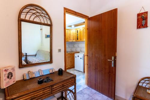 a bathroom with a wooden vanity and a mirror at Country House Elaionas 