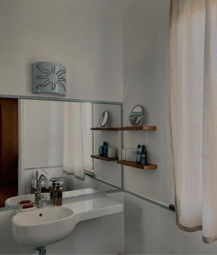 a white bathroom with a sink and a window at Villa Alma - S4199 in Santa Margherita di Pula