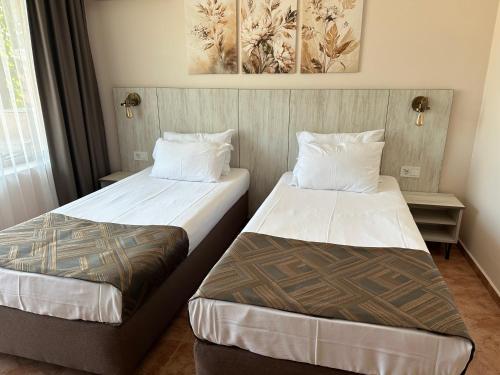 a hotel room with two beds in a room at Oleander House and Tennis Club in Sunny Beach