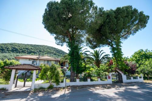 a house with a tree and a fence at Country House Elaionas 