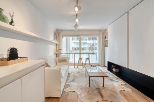 a living room with a couch and a table at StudioV in Knokke-Heist