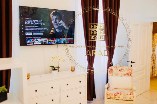 a bedroom with a movie poster and a chair at Fabulous Bulevard Ultracentral Apartament in Arad