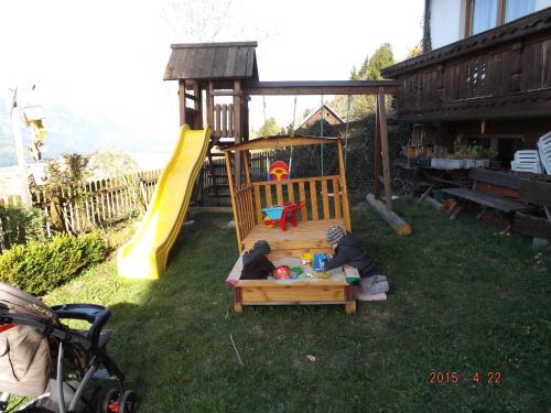 a playground with kids playing in a sandbox at Erlebnishof Schiman in Kirchbach