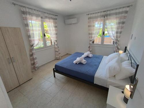 a bedroom with a bed with a stuffed animal on it at Holiday Home Klimataria in Áyios Pétros