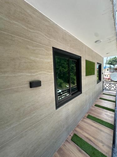 a house with a window on the wall at Bhurban Suites in Bhurban