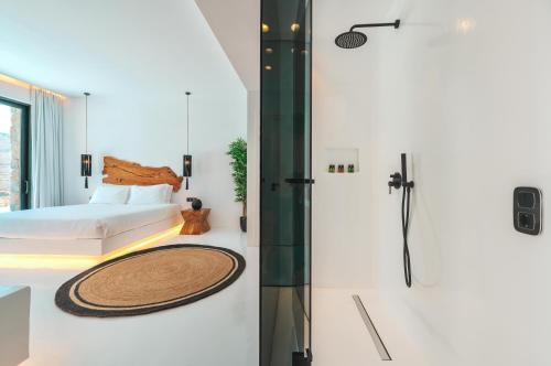 a bedroom with a bed and a shower at Mega Mansions Mykonos in Elia