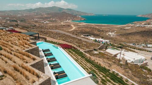 an overhead view of a swimming pool and the ocean at Mega Mansions Mykonos in Elia