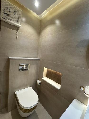 a small bathroom with a toilet and a sink at Bhurban Suites in Bhurban