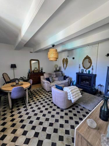 a living room with a couch and a table at L'uzanges in Lussan