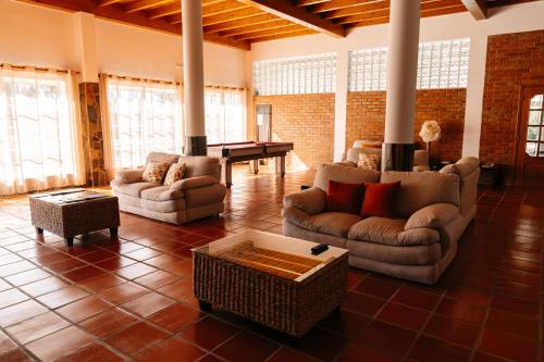 a living room with couches and a pool table at Herdade do Sardanito da Frente in Zambujeira do Mar