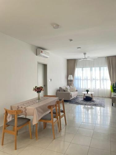 a living room with a table and chairs and a couch at Cozy Aesthetic Apartment near KLIA Airport in Sepang