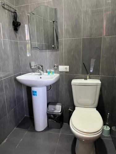 a bathroom with a toilet and a sink at Hotel Eight in Tbilisi City