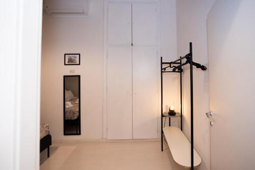 a room with a white wall and a mirror at Persia Collection Colosseo in Rome