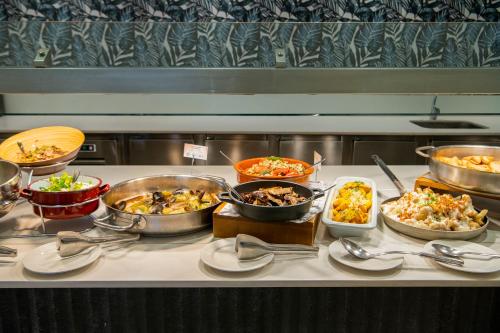 a buffet with many different types of food on a table at Hotel Tahití Playa in Santa Susanna