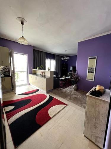 a living room with a red black and white rug at City View Loft in Chania Town