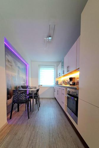 a kitchen with a table and a dining room at Ferienwohnung Lion in Oschersleben