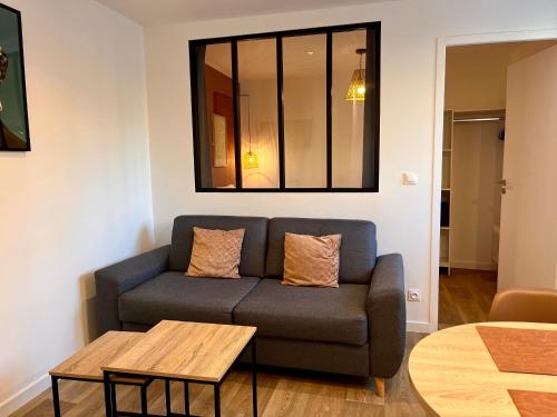 a living room with a couch and a table at Le Quarante cinq -6 in Laval