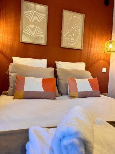 a bedroom with two beds with pillows at Le Quarante cinq -6 in Laval
