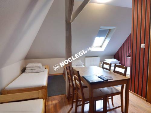 a room with a table and a bed and a desk at Noclegi u Matyldy in Marklowice