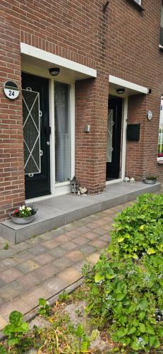 a cat is sitting on the porch of a building at Huis bij het water in uitstekend fiets-, vis- en vaargebied in Jutrijp
