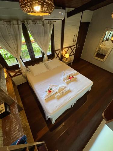 a bedroom with a bed with two towels on it at Pousada Naiepe in Fernando de Noronha