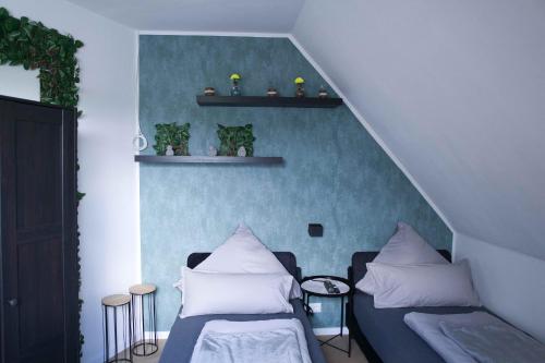 a room with a bed and a couch with pillows at Heide Ferienwohnung West Nr-4 in Schneverdingen