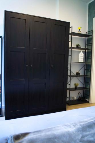a black closet with shelves in a room at Heide Ferienwohnung West Nr-4 in Schneverdingen