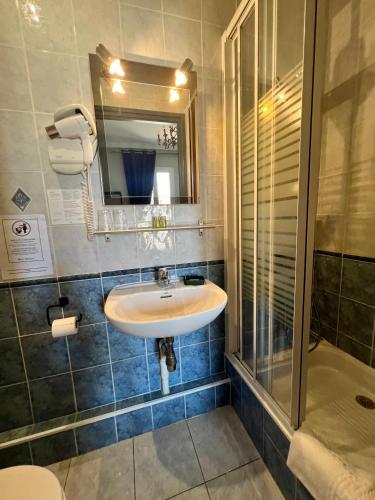 a bathroom with a sink and a shower at Hotel Le Ponteil in Antibes