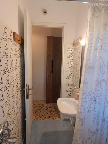 a bathroom with a sink and a toilet in it at Niki Seaside Apartments in Platamonas